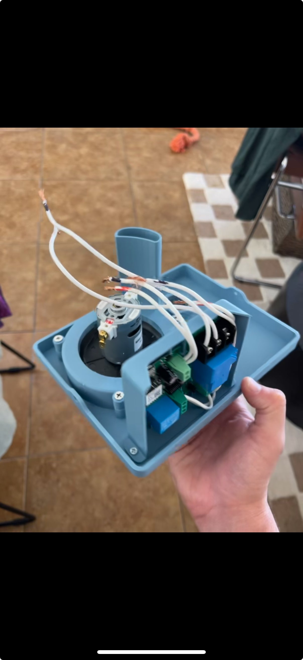 Hand-held open Unclog prototype showing its motor, control board, relays, wiring, and 3D-printed enclosure
